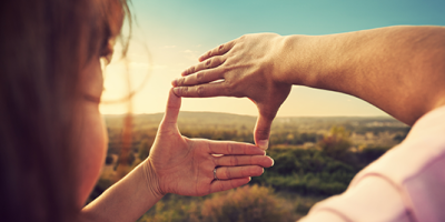 using hands to highlight a section of the countryside for a photo