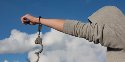 man in hoody with handcuffs