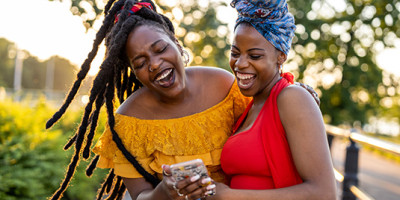 Two female friends hugging and laughing