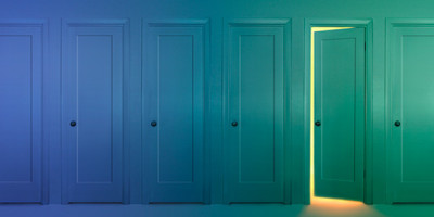 several closed doors with one cracked open