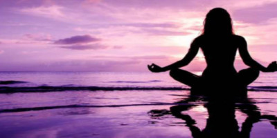 woman meditating on the water